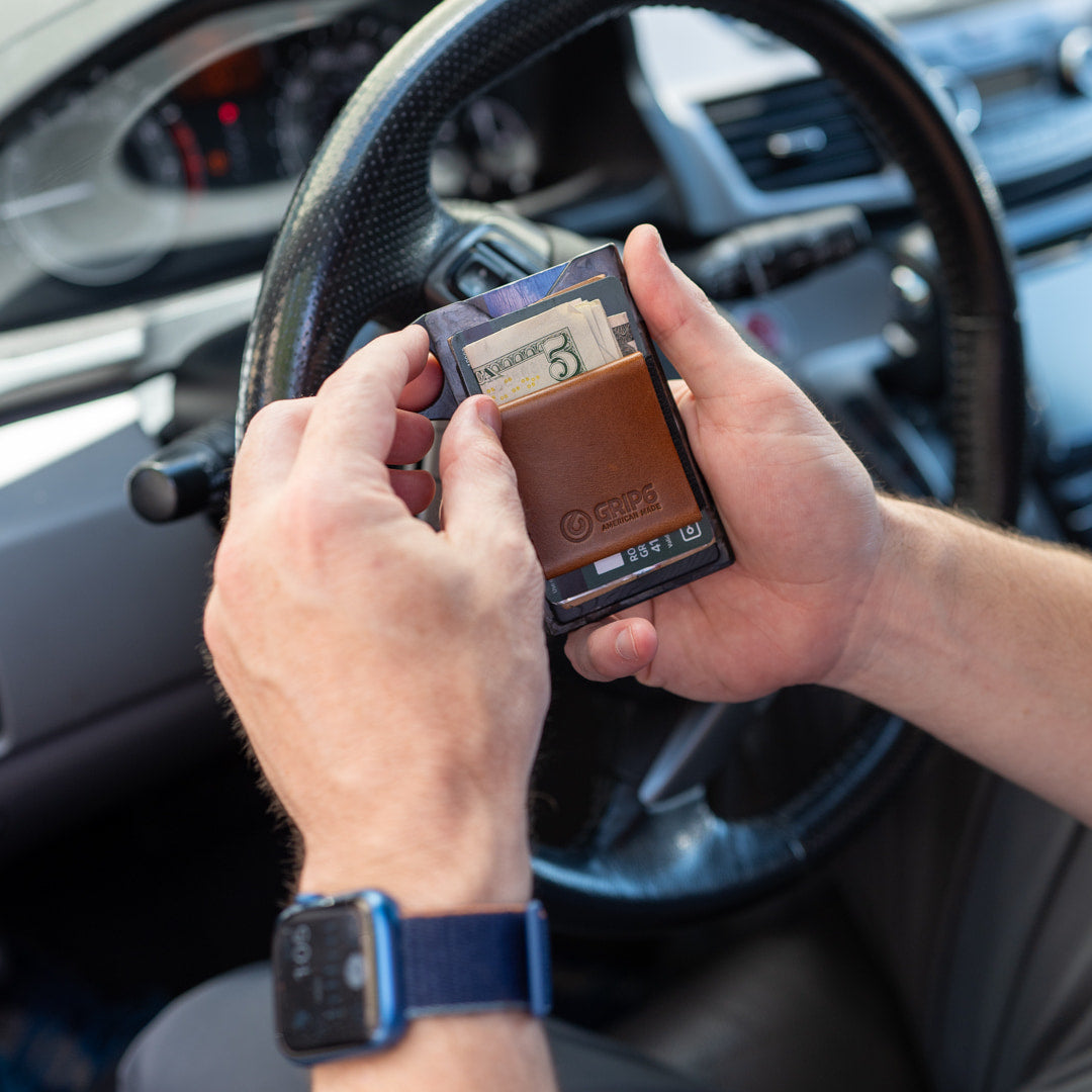 man holding wallet with leather money band