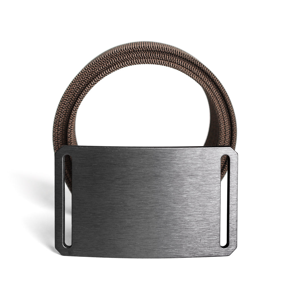 gunmetal belt buckle in front of tan belt strap